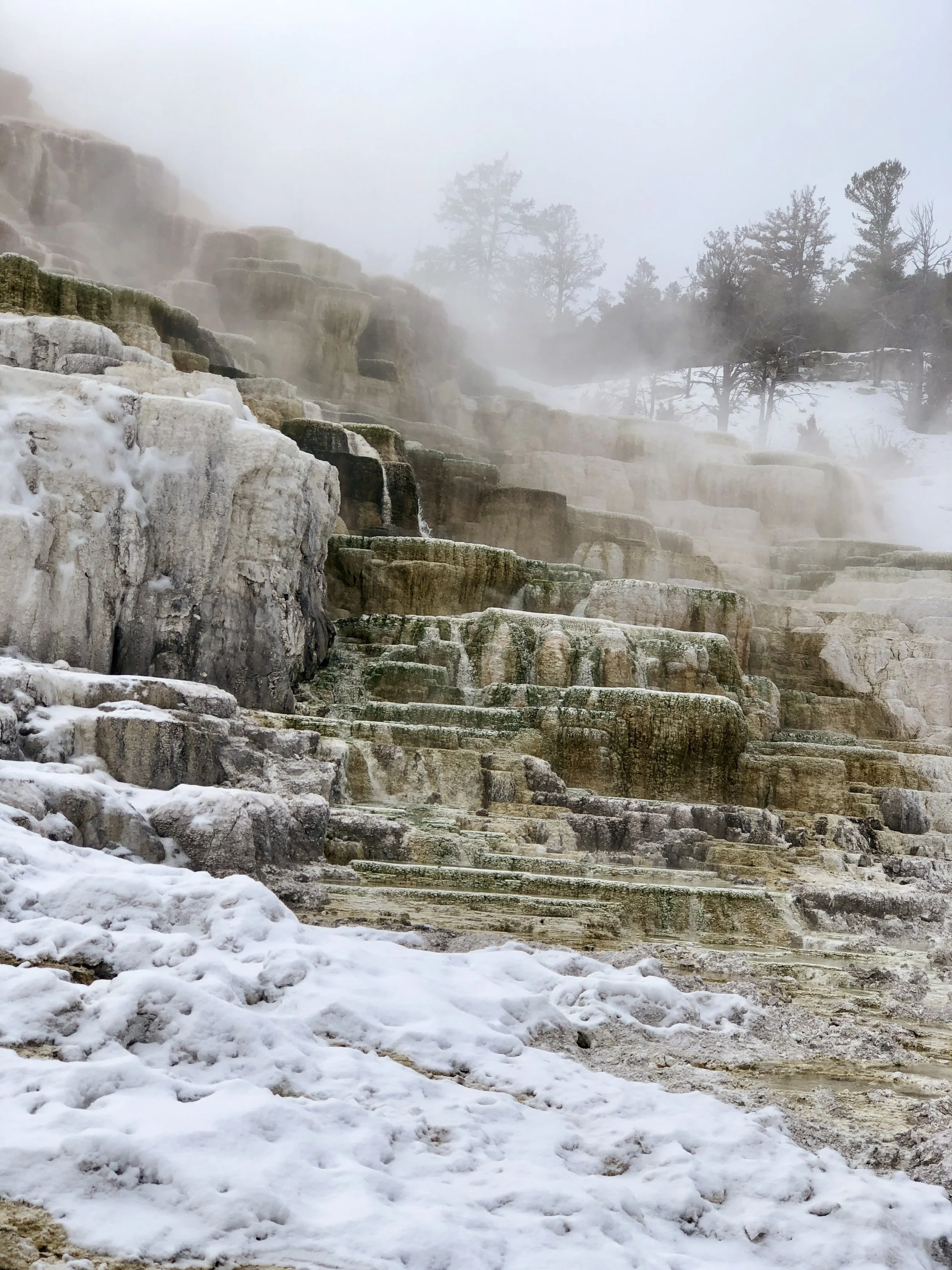 Snow-dusted hot spring terraces in winter